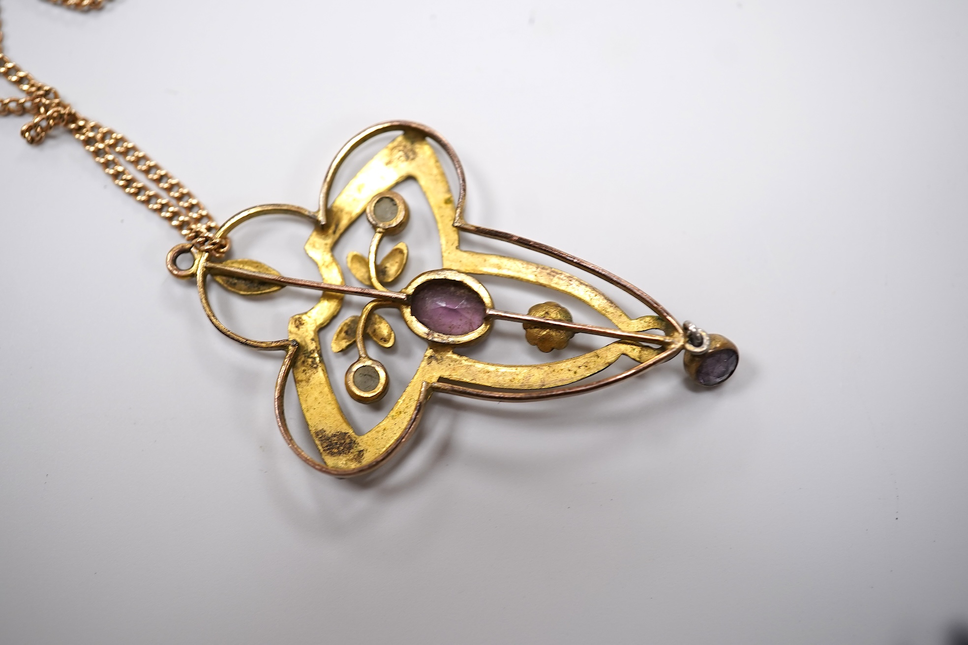 An early 20th century yellow metal, amethyst and seed pearl set pendant, 41mm, on a yellow metal chain, together with other assorted jewellery and other items including a late Victorian 9ct gold brooch, a coin bracelet,